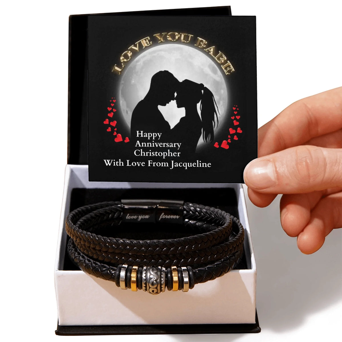 Black leather bracelet with metal charms in a box with a personalized card.