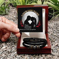Personalized leather bracelets in a wooden box with an engraved message, set against a natural stone background.