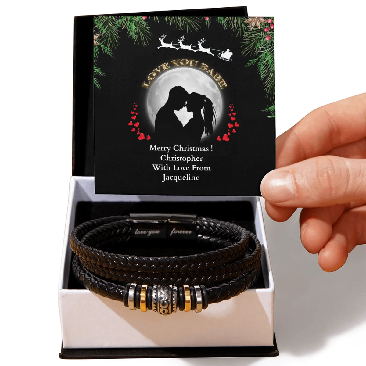 Black leather bracelet with metal charms in a box with a personalized card.