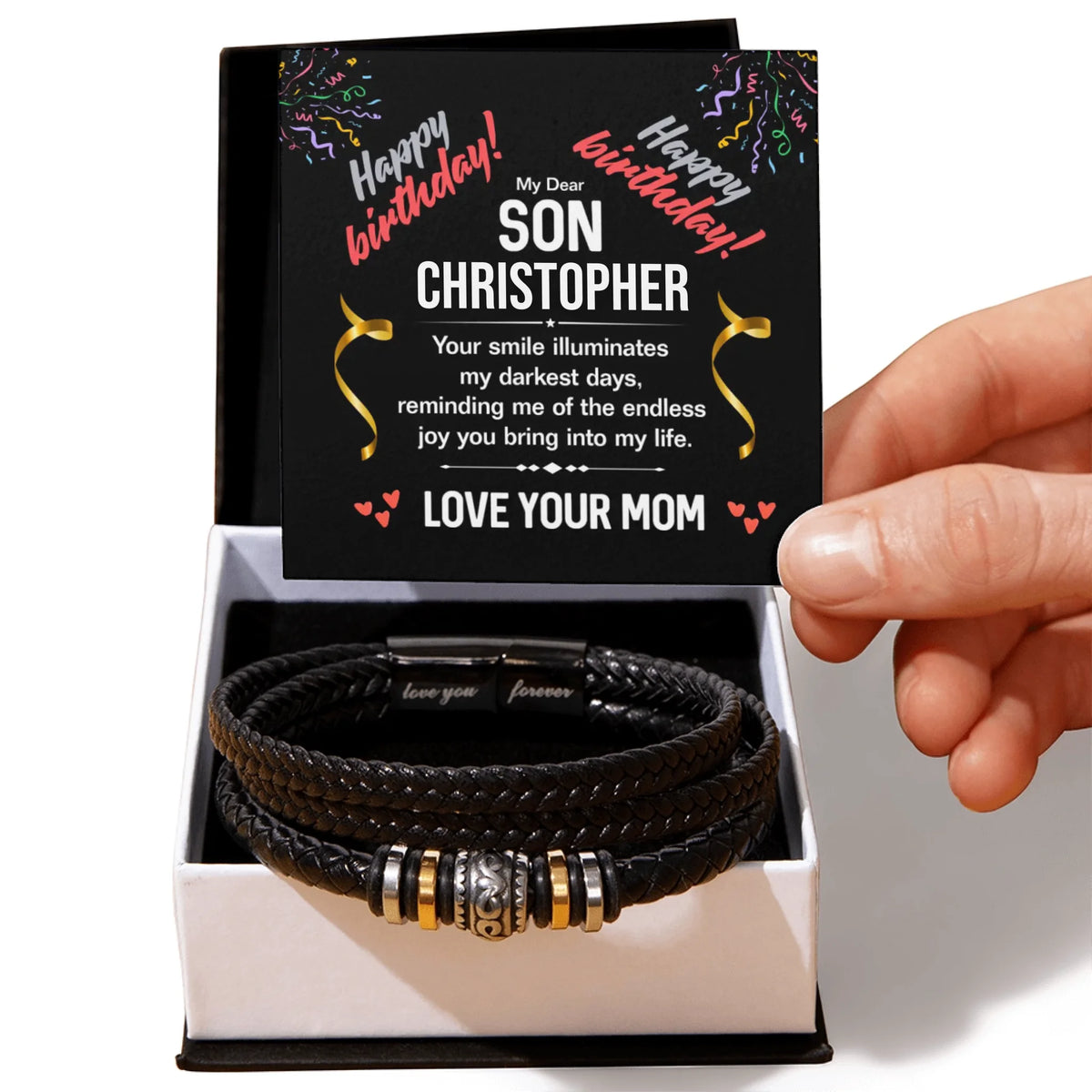 Black leather bracelet with charms in a box with a personalized birthday card for a son.