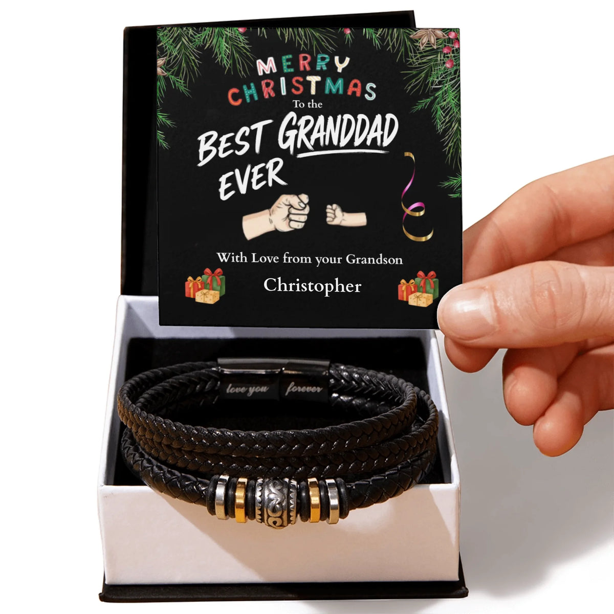 Black leather bracelet with metal charms in a box with a personalized Christmas card.