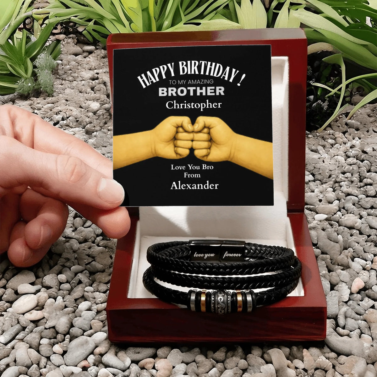 Personalized birthday gift for a brother with bracelets and a card on pebbles.