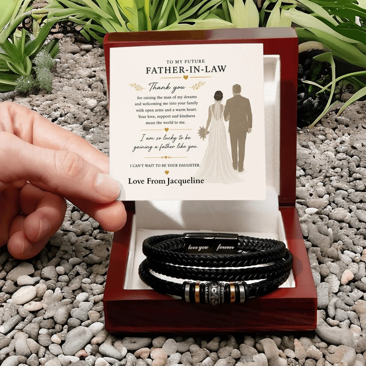 Bracelets in a box with a personalized card for future father-in-law on a pebbled surface.