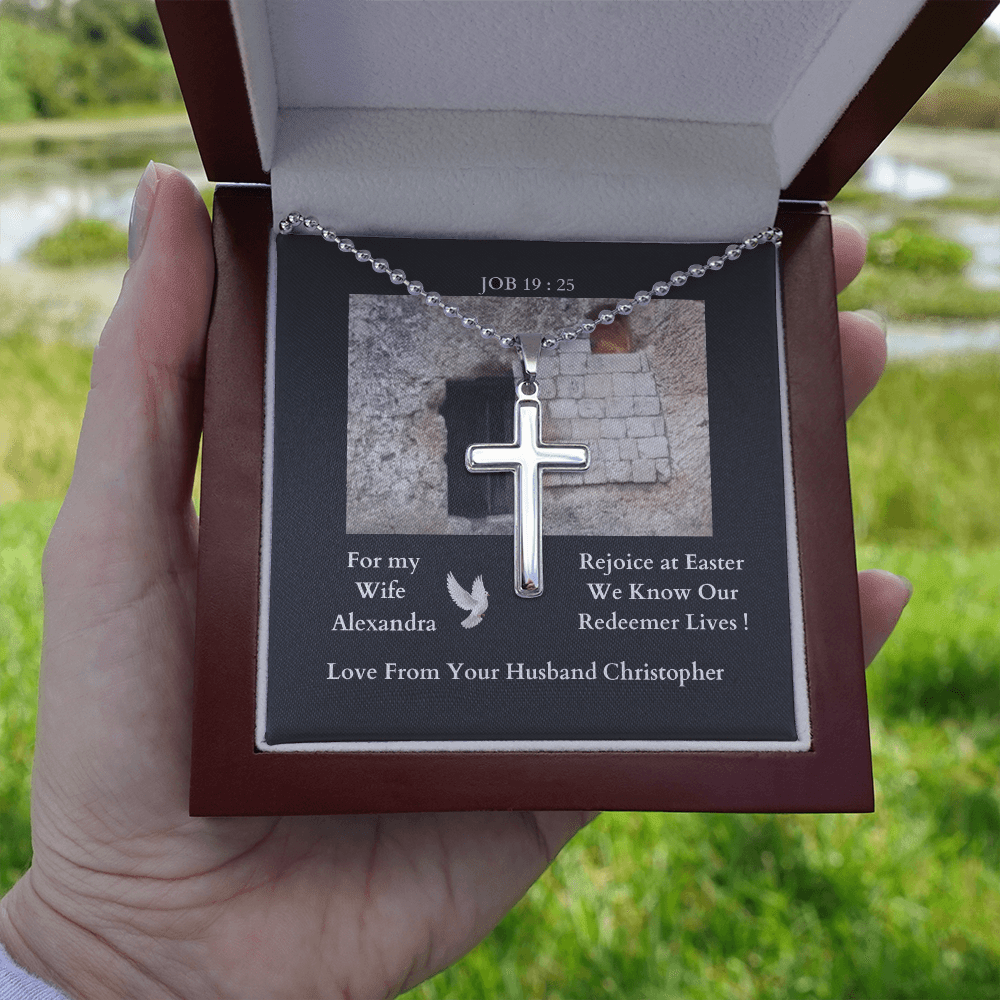polished-stainless-steel-christian-cross-with- military-style-ball-chain-necklace-in-led-lit-mahogany-jewelry-gift-box-with-arrow-pointing-to-how-the-cross-can-be-engaved-on-its-back-held-in-human-hand
