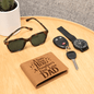 Leather -wallet- with- graphic -design- sitting- on- Table- top -with- watch -car -keys- and -Sun- Glasses.