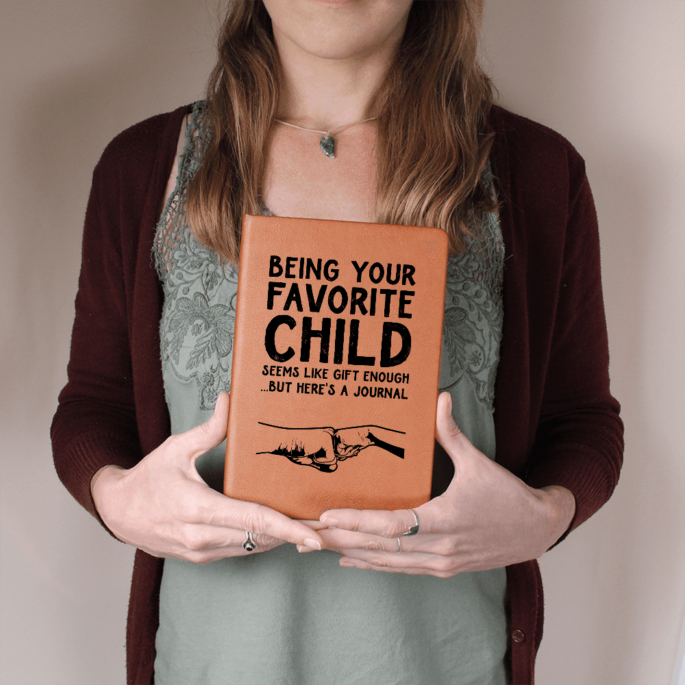young-woman-holding-leather -journal-with -graphic- message-printed -on the- cover.