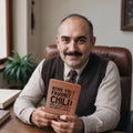 middle-aged-man-holding-leather-journal-with-graphic-text-design-on-the-cover.